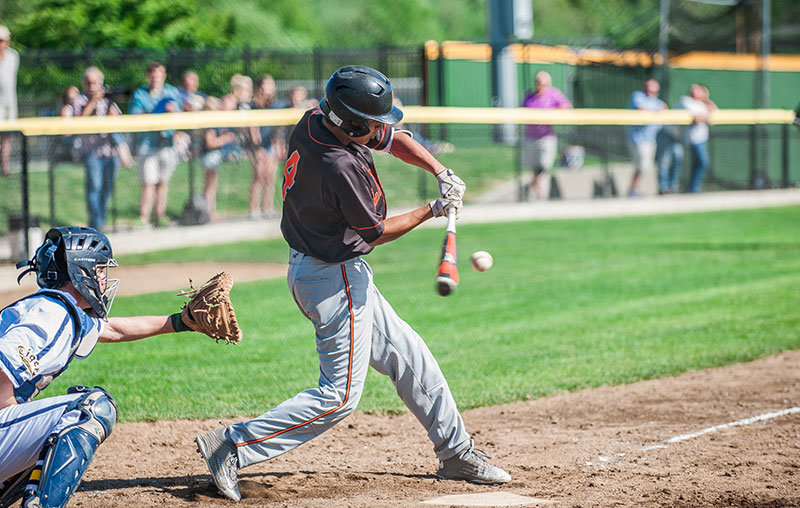 Chase Abshere connects with a pitch during a 2–1 victory against Burlington-Edison. Photo by Janell Kortlever